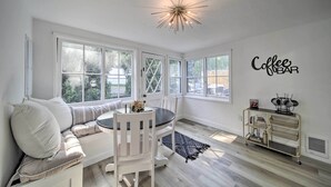 A bright, white room with a round table, white chairs, a sofa, and a coffee bar sign on the wall. - Bright & Airy Liberty Lake Abode w/ Backyard! (Liberty Lake)