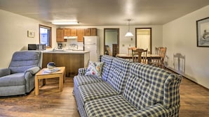 A compact living space with a kitchenette, a sofa, a chair, and a dining table. - Charming Columbus Apt Along Yellowstone River (Columbus)
