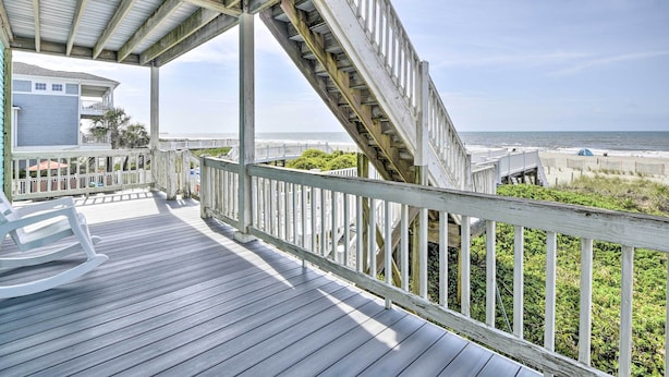 A wooden deck with a white railing overlooking a beach. - Large-group Getaway - Beachfront Home w/ Pool! (Supply)