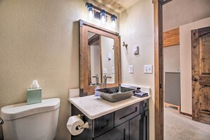 A bathroom with a toilet, sink, and mirror. - Beautiful Mccall Cabin: Perfect for Families! (McCall)