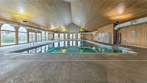 An indoor swimming pool with a wooden ceiling and large windows. - Bright Manistee Condo w/ Beach + Pool Access! (Manistee)