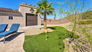 A house with a garage, a palm tree, and a small lawn with a golf flag. - 4 Mi to Lake Havasu State Park: Home w/ Pool (Lake Havasu City)