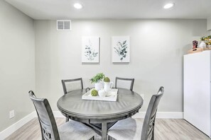 A dining area with a round table, four chairs, and two wall-mounted artworks. - 2 Mi to Dtwn Gilbert! Snowbird Escape w/ Pool (Gilbert)
