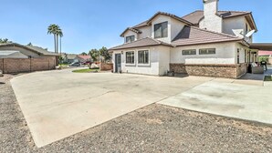 A two-story house with a brick facade, a chimney, and a driveway leading to the front door. - 2 Mi to Dtwn Gilbert! Snowbird Escape w/ Pool (Gilbert)