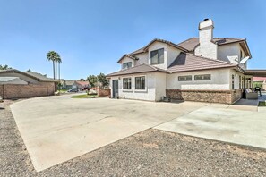 A two-story house with a brick facade, a chimney, and a driveway leading to the front door. - 2 Mi to Dtwn Gilbert! Snowbird Escape w/ Pool (Gilbert)