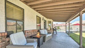 An outdoor covered patio with wicker furniture, a fire feature, and a view of the neighborhood. - 2 Mi to Dtwn Gilbert! Snowbird Escape w/ Pool (Gilbert)
