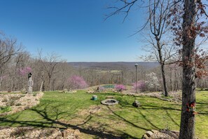 A park with a stone monument, a fire pit, and a pond. - 'bullfrog Bluff' Mountain View Cabin w/ Deck! (Mountain View)