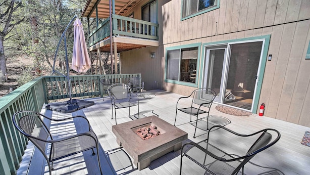 A wooden deck with outdoor seating, a fire pit, and a covered area with a balcony. - 'the Crooked Pot Cabin' Near Hiking + Dining! (Pine)