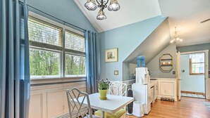 A dining area with a white table, chairs, and a potted plant. - Pet-friendly Pond View Loft' w/ Private Pool! (Pine Bush)
