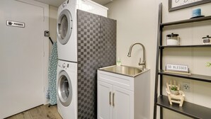 A laundry room with a private sign, a washing machine, a dryer, a sink, and a shelf with a 'So Blessed' sign. - Lake House Haven: Fire Pit, Boat Dock + More! (Johnson City)