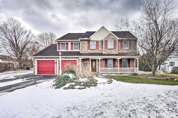 A two-story house with a red garage door, stone facade, and a small porch. - East Earl Retreat w/ Hot Tub < 4 Mi to Town! (East Earl)