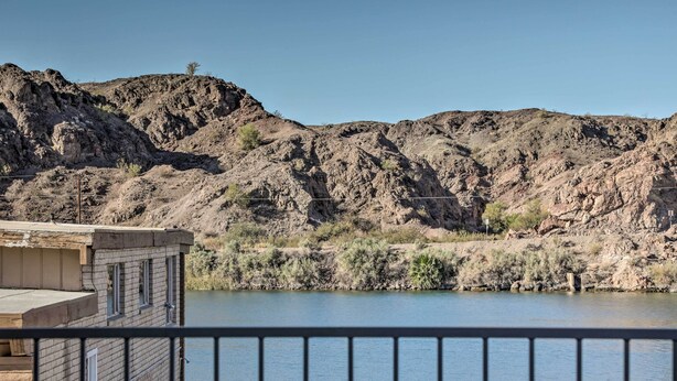 A balcony overlooking a river with rocky hills in the background. - Parker Home on the Colorado River w/ Views! (Parker)