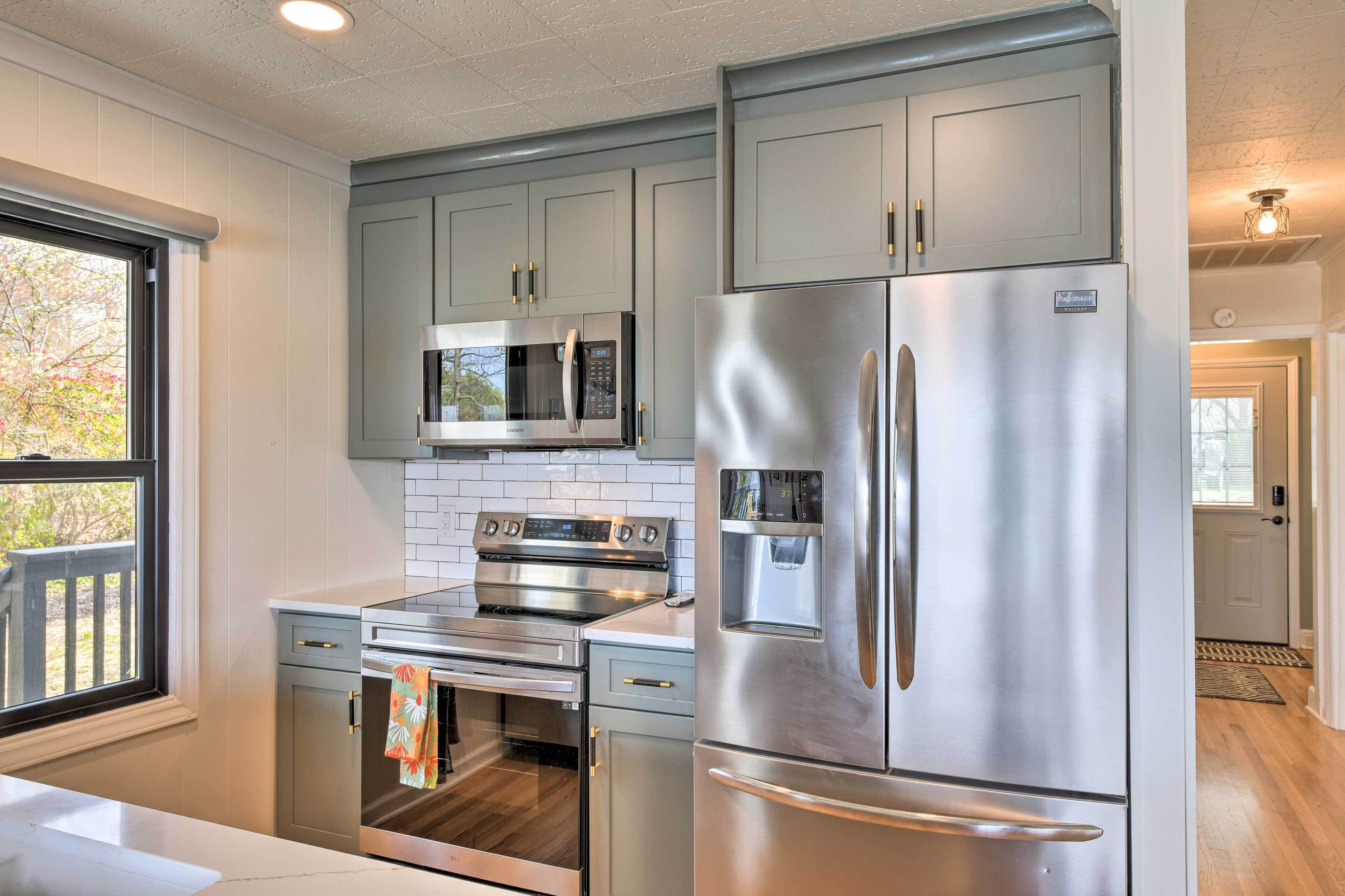 A modern kitchen with stainless steel appliances, a built-in oven, and a microwave.