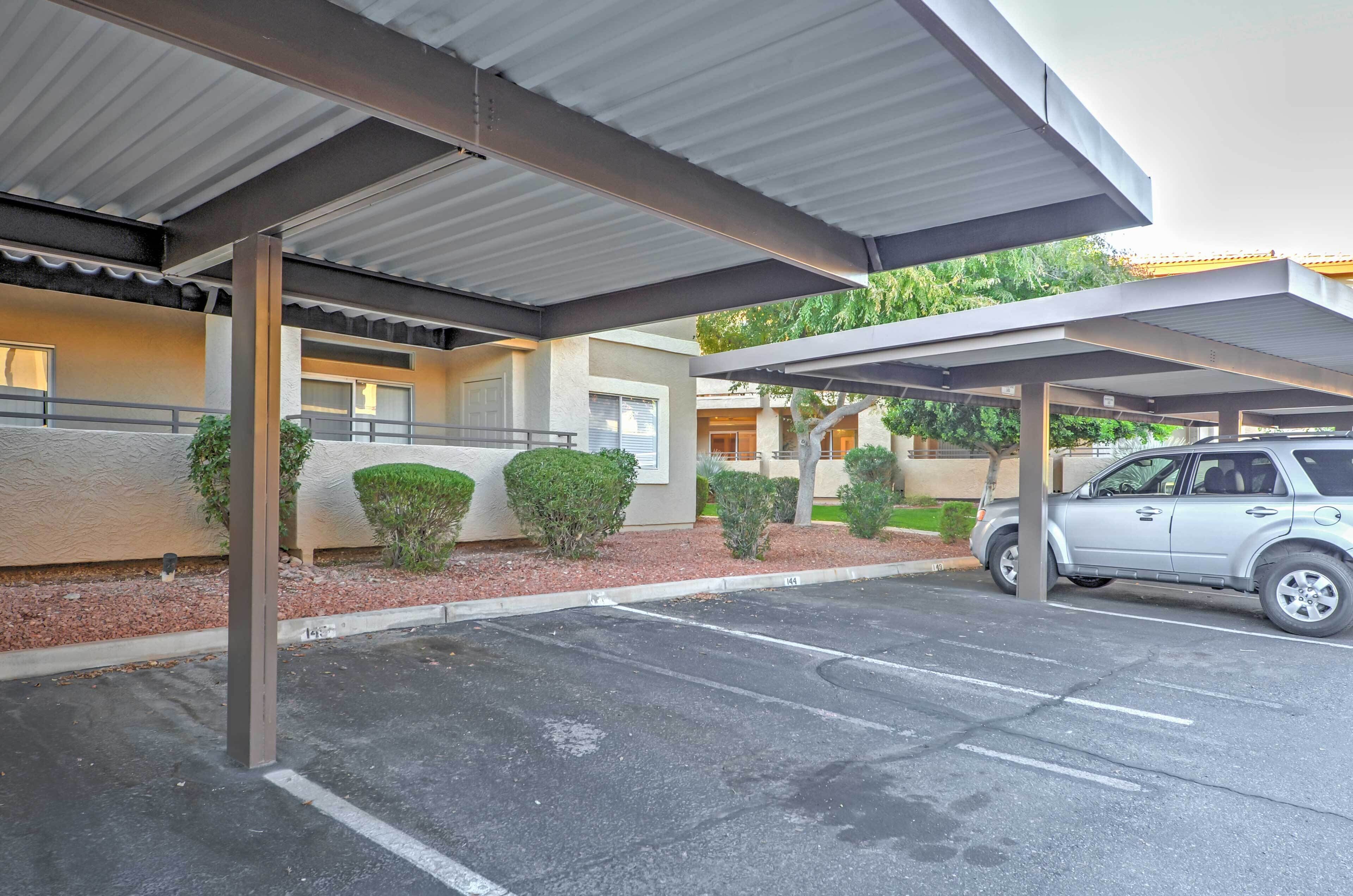 A covered parking area with a car parked under a shelter.