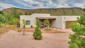 A modern house with a patio, surrounded by a gravel driveway and small trees. - Sedona Retreat w/ Patio, Bar & Swim Spa! (Sedona)