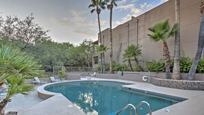 A swimming pool with lounge chairs and palm trees. - Tucson Desert Retreat w/ Pool + Hot Tub Access! (Tucson)