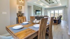 A dining area with a wooden table, chairs, and a ceiling fan. - Picturesque Texas Gulf Coast Home in Port Isabel! (Port Isabel)