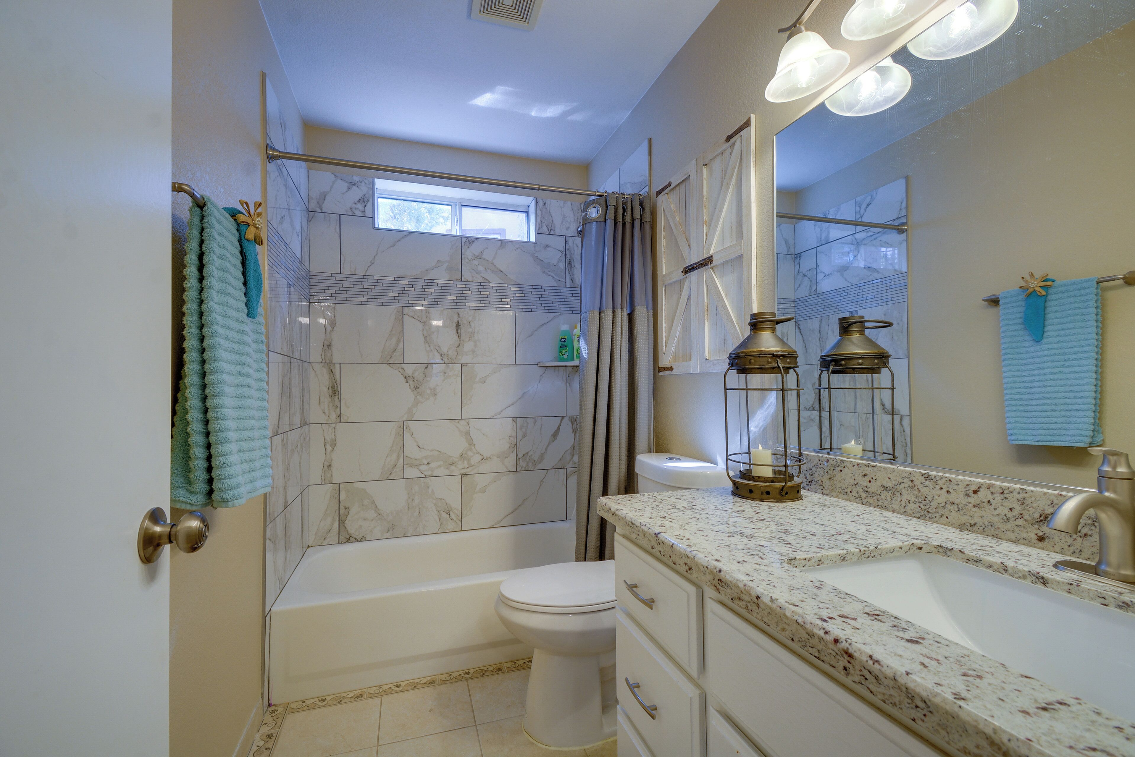 A bathroom with a bathtub, toilet, and sink.