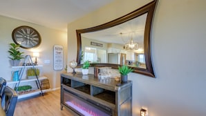 A modern kitchen with a built-in fireplace, wooden cabinets, and a large mirror. - Game Room + Mtn-view Deck: Prescott Escape! (Prescott)