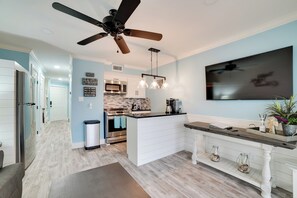 A modern kitchen with a central island, stainless steel appliances, and a ceiling fan. - Pool & Direct Beach Access: Corpus Christi Escape (Corpus Christi)