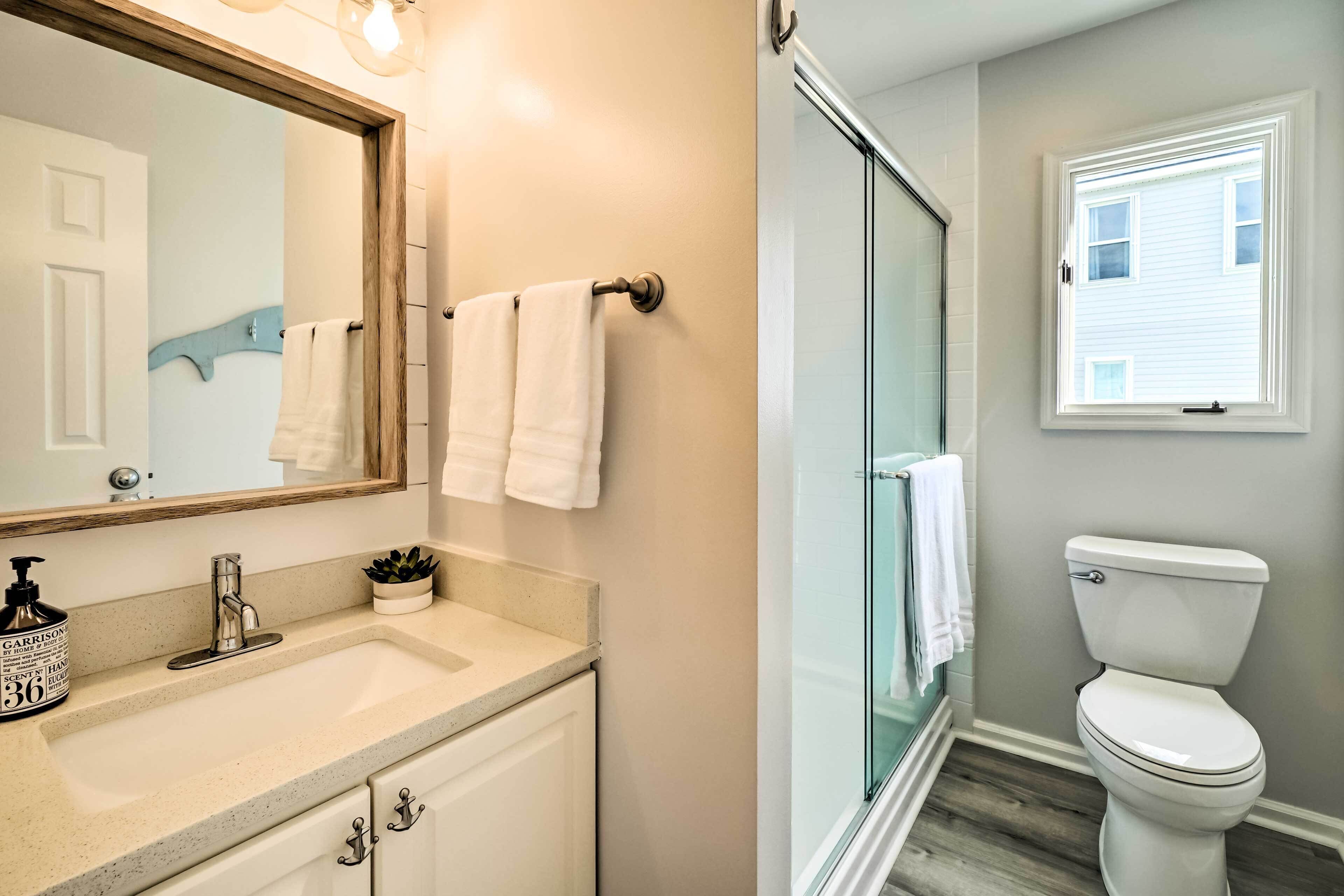 A bathroom with a sink, mirror, and toilet.