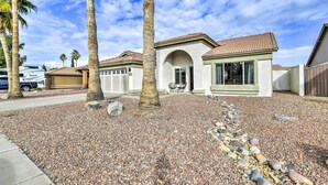 A residential property with a tiled roof, a stone pathway, and palm trees. - Pool, BBQ & Patio: Gilbert Getaway Near Golfing (Gilbert)