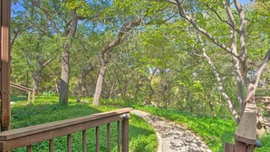 A wooden pathway leading through a forested area with a wooden railing on one side. - Lake Granbury Getaway! Family Home w/ Deck & Games (Granbury)
