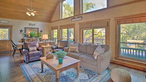 A spacious living room with a high ceiling, large windows, and a cozy seating area. - Lake Granbury Getaway! Family Home w/ Deck & Games (Granbury)