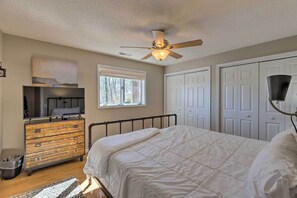 A bedroom with a bed, dresser, ceiling fan, and a window. - Massanutten Resort Home w/ Deck + Mountain Views! (McGaheysville)