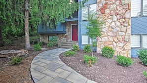 A house with a stone facade, a red door, and a stone pathway leading to the entrance. - Massanutten Resort Home w/ Deck + Mountain Views! (McGaheysville)