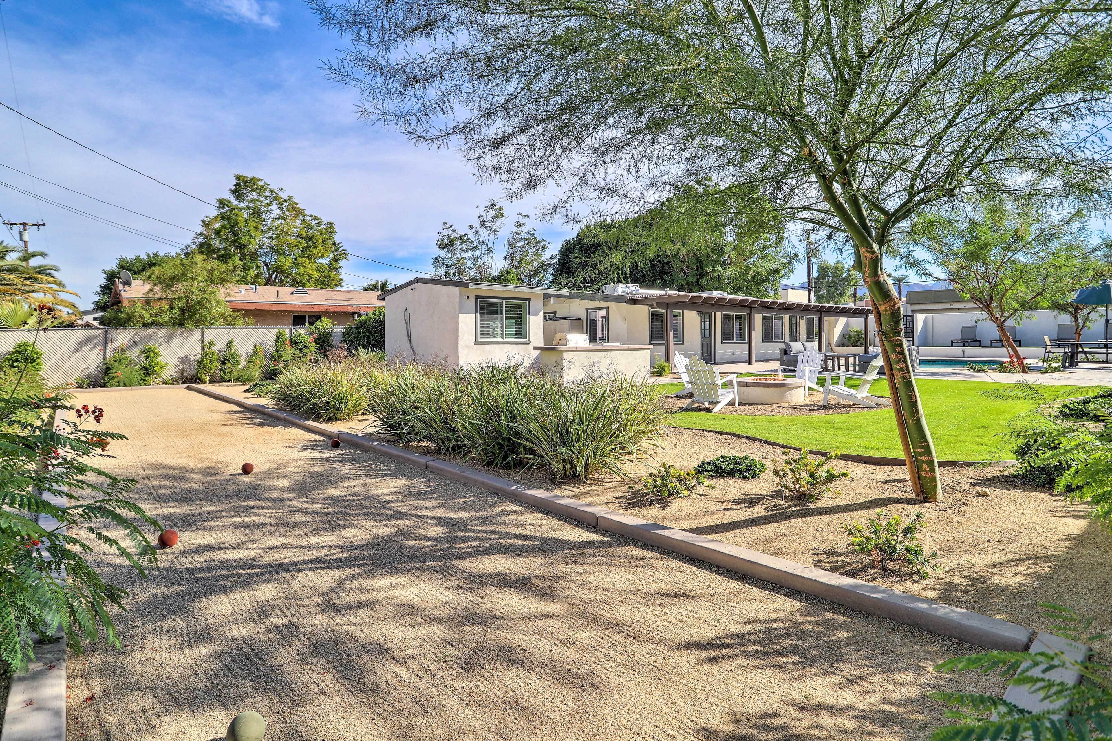 A residential property with a house, a fenced yard, and a pool area.