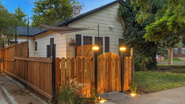 A house with a wooden fence, a covered patio, and a well-maintained lawn. - Ski & Hike: Cozy Dtwn Reno Studio w/ Fireplace (Reno)