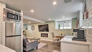 A modern kitchen with a built-in microwave, stainless steel refrigerator, and a coffee machine. - Ski & Hike: Cozy Dtwn Reno Studio w/ Fireplace (Reno)