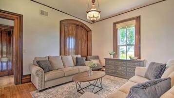 A living room with a sofa, a coffee table, and a dresser.