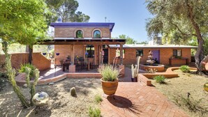 A brick house with a patio, outdoor seating, and a large potted plant. - Eclectic Tucson Home 2 Mi to Saguaro National Park (Tucson)