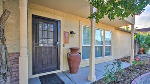 A house with a dark brown door, a large terracotta pot, and a window with blinds. - Glendale Oasis w/ Fenced Yard & Private Pool! (Glendale)