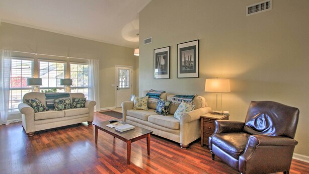 A living room with two sofas, a coffee table, a leather armchair, and a lamp. - Glendale Oasis w/ Fenced Yard & Private Pool! (Glendale)
