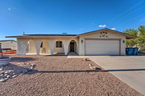 A single-story house with a garage, a driveway, and a gravel area with rocks. - Pool & Boat Parking 1 mi to Lake (Lake Havasu City)