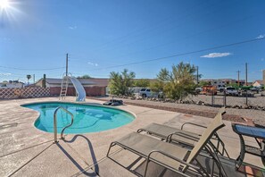 A swimming pool with a slide, surrounded by lounge chairs and a ladder. - Pool & Boat Parking 1 mi to Lake (Lake Havasu City)