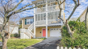 A two-story building with a balcony, a red door, and a garage. - Beach, Pier Access! Pet-friendly Crystal Coast Gem (Morehead City)