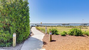 A pathway leading to a dock with a clear view of the water and a pier in the distance. - Beach, Pier Access! Pet-friendly Crystal Coast Gem (Morehead City)