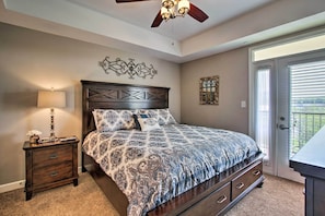 A bedroom with a bed, a nightstand, a ceiling fan, and a door leading to a balcony. - Sevierville Resort Retreat ~ 2 Mi to Pigeon Forge! (Sevierville)