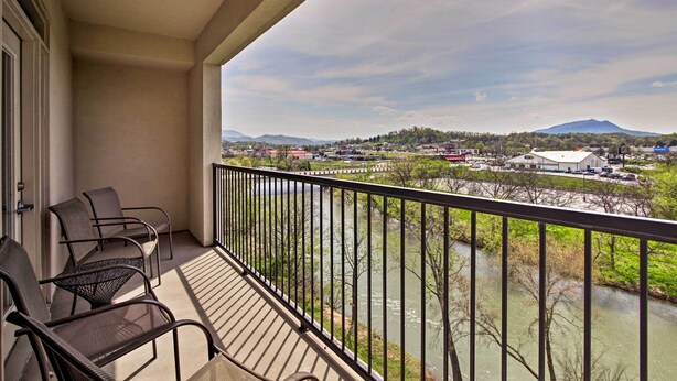 A balcony with chairs overlooking a river and a distant mountain. - Sevierville Resort Retreat ~ 2 Mi to Pigeon Forge! (Sevierville)