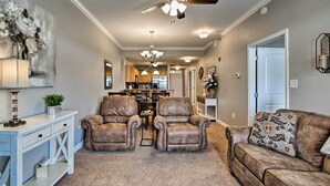 A living room with a ceiling fan, a chandelier, and a dining area in the background. - Sevierville Resort Retreat ~ 2 Mi to Pigeon Forge! (Sevierville)