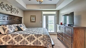 A bedroom with a bed, a ceiling fan, a dresser, and a television. - Sevierville Resort Retreat ~ 2 Mi to Pigeon Forge! (Sevierville)