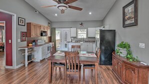 A spacious kitchen with wooden cabinets, a dining table, and a ceiling fan. - Mt Juliet Getaway w/ Yard: 22 Mi to Nashville (Mount Juliet)