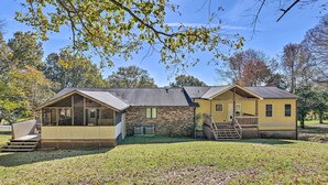 A two-story house with a covered porch and a small deck, surrounded by a grassy yard and trees. - Mt Juliet Getaway w/ Yard: 22 Mi to Nashville (Mount Juliet)