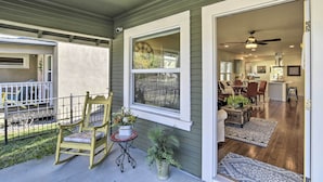A porch with a rocking chair, a small table, and potted plants. - Ideally Located Chico Home - Fire Pit & Grill (Chico)