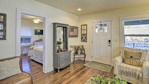 A room with a bed, a dresser, a chair, and a window with a view of the street. - Ideally Located Chico Home - Fire Pit & Grill (Chico)