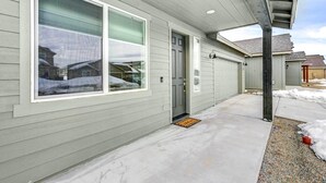 A residential building with a large window, a door, and a covered porch area. - 12 Mi to Dtwn Flagstaff: Spacious Bellemont Home! (Bellemont)